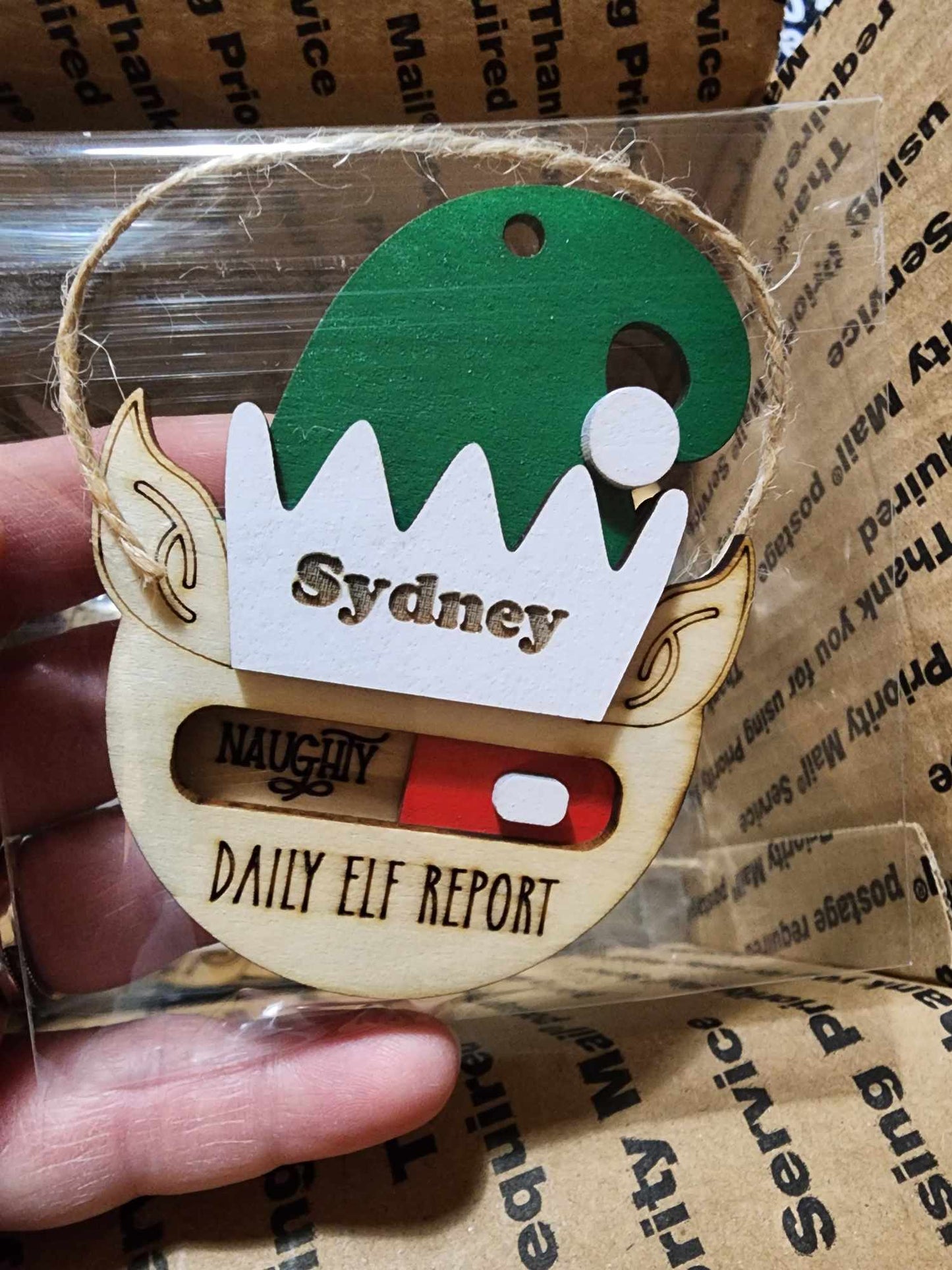 Daily elf report ornament, toggles between naughty and nice